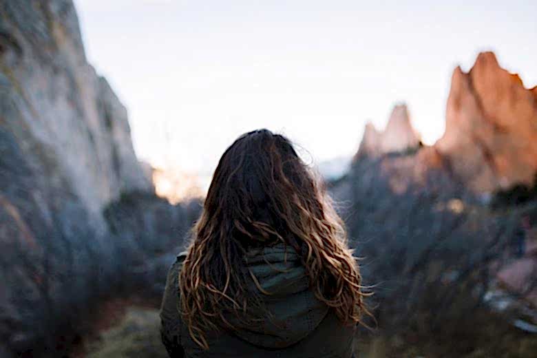 woman standing in front of mountains