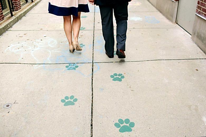 man and woman walking down a sidewalk