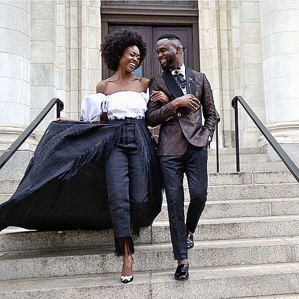 couple walking down the stairs after getting married