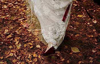 bride walking in leaves