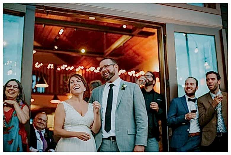 couple laughing at their wedding feel the wedding day love