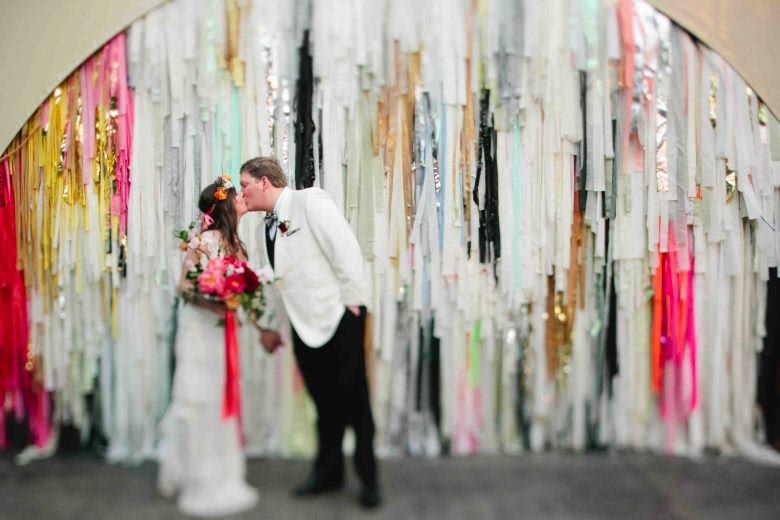 couple in front of the color condition background with wedding colors