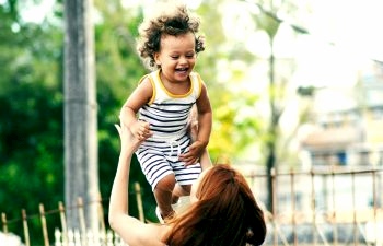 mom tossing her kid in the air
