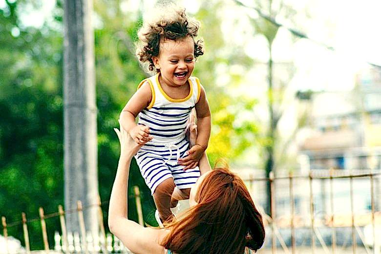 mom tossing her kid in the air