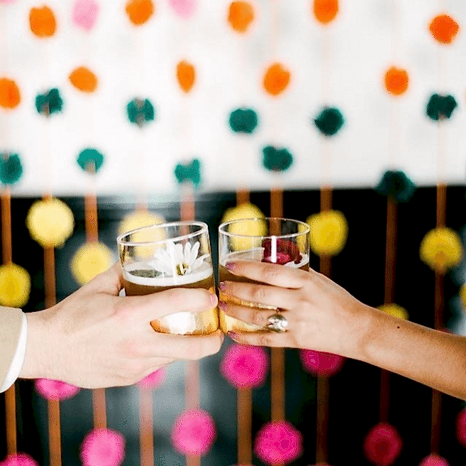 man and woman clinking glasses