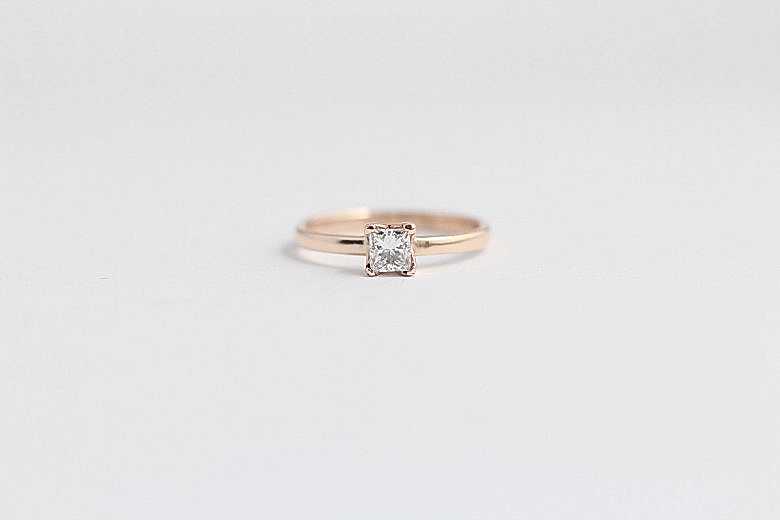 wedding ring from ash hilton with a rose gold band and square solitaire diamond