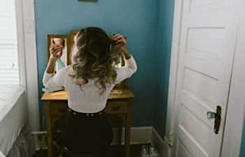 woman sitting at a mirror