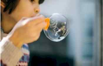 kid blowing bubbles
