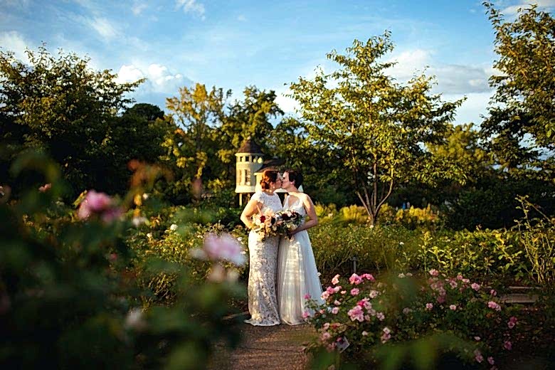 two brides kissing