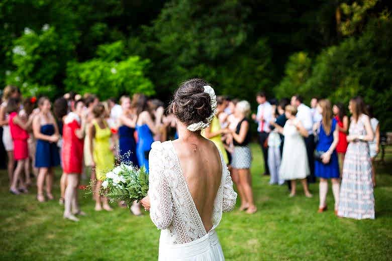 bride standing in front of wedding group