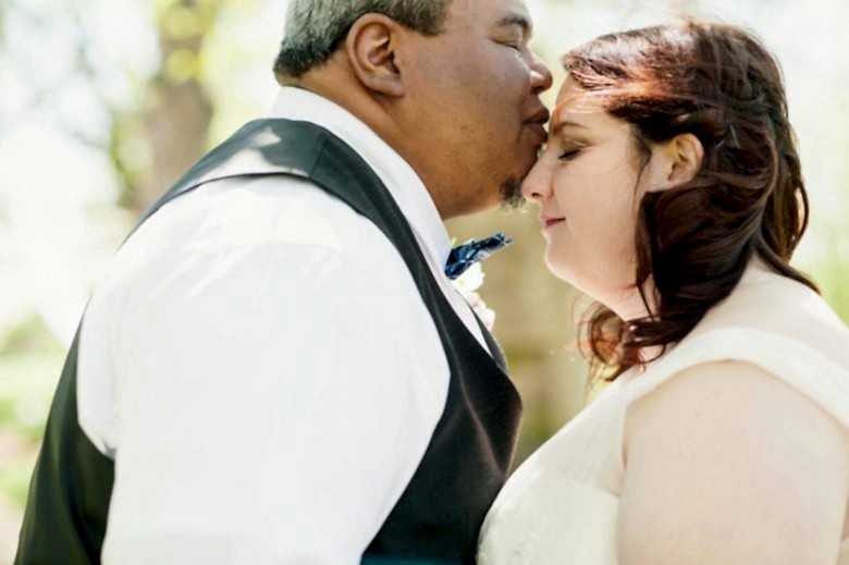 a couple kissing on their wedding day by you are raven