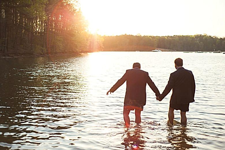 a couple walking into a lake