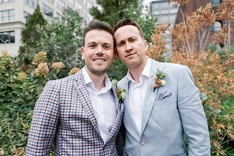 portrait of two grooms in a park