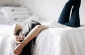 woman lying on a bed