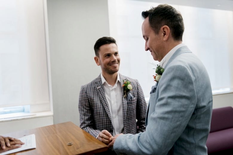 two grooms exchanging rings at New York City Hall