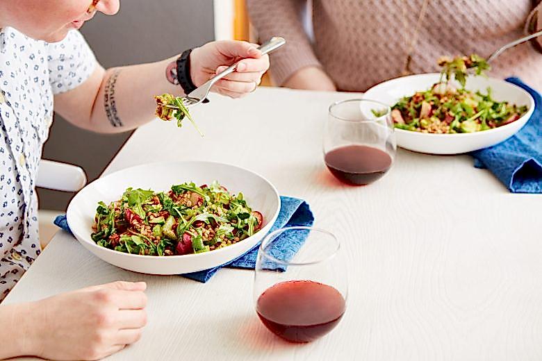 a couple eating a meal from blue apron