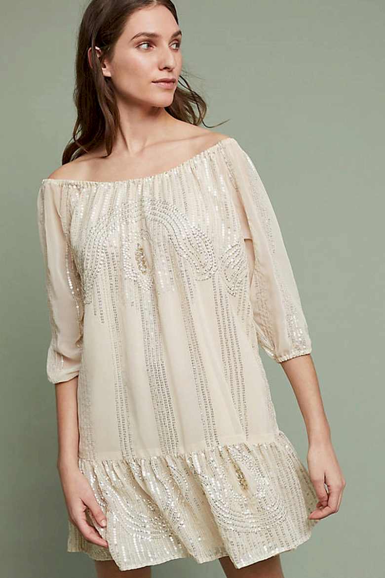 boatneck cream dress with silver sequins on woman