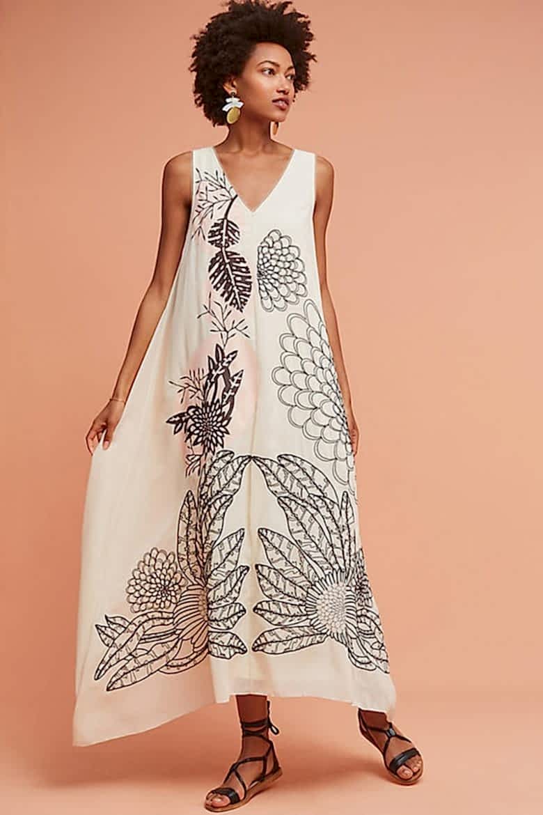natural hair model with loose illustrated cream sleeveless dress