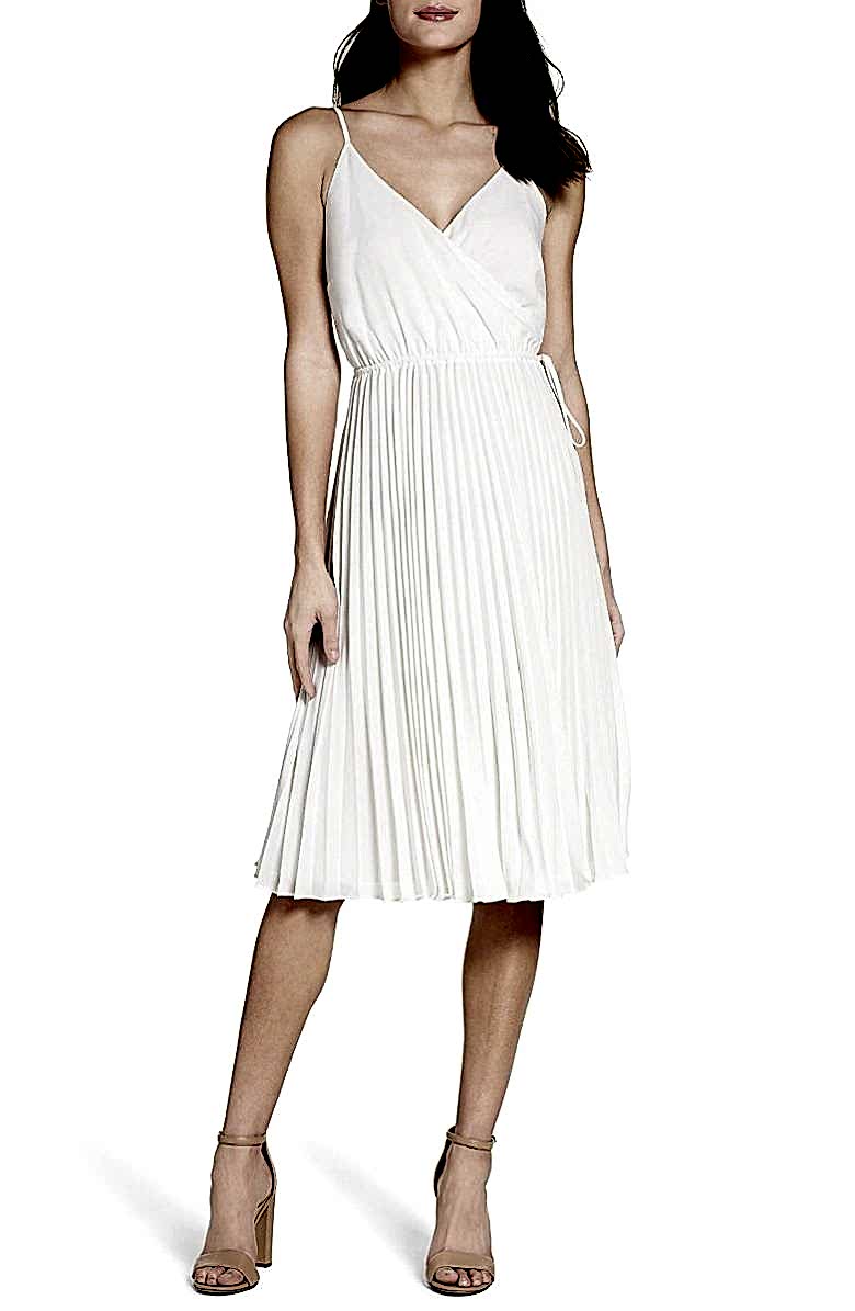 woman in pleated white strappy white dress