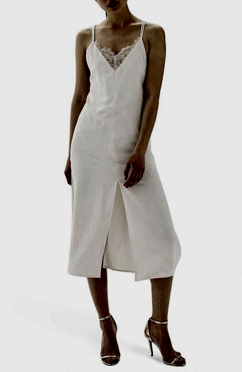 woman in white slip dress with lace neckline detail