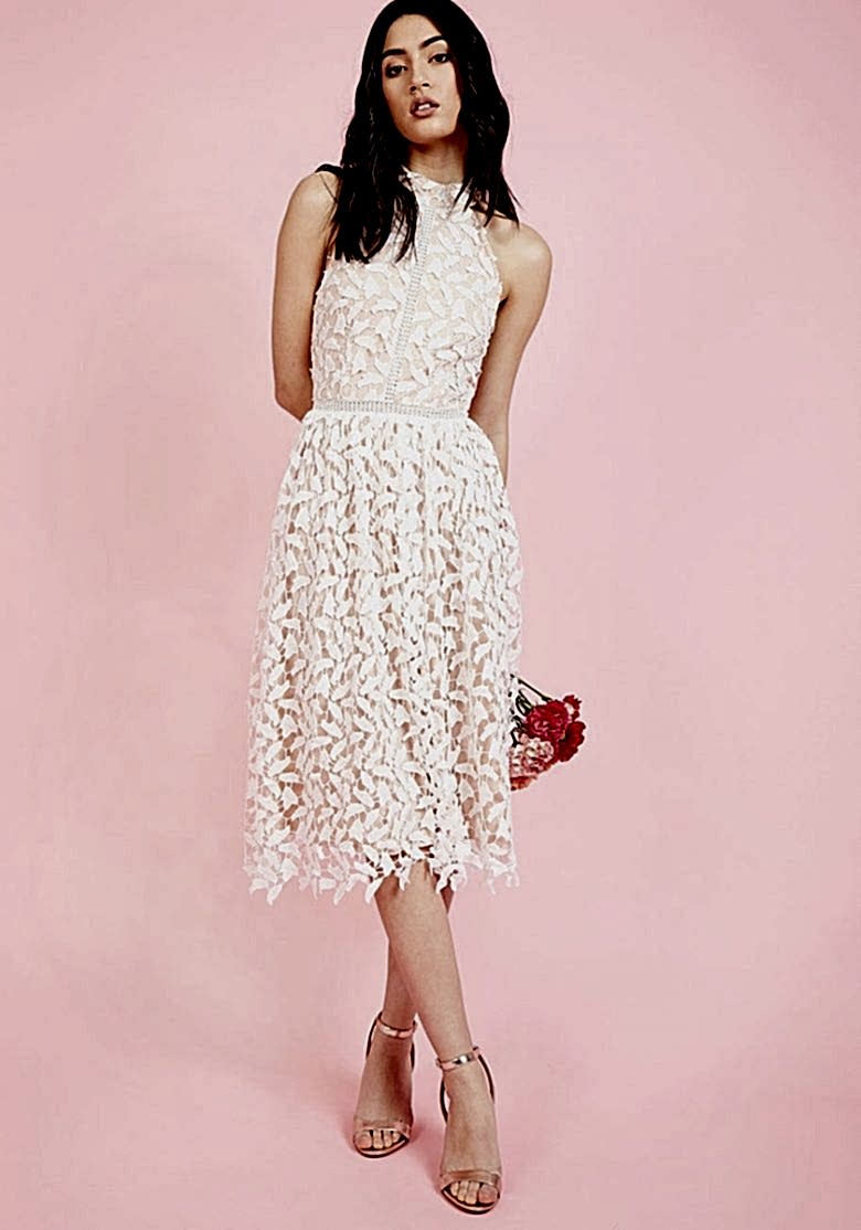 woman in sleeveless lace bridal shower dress on pink background