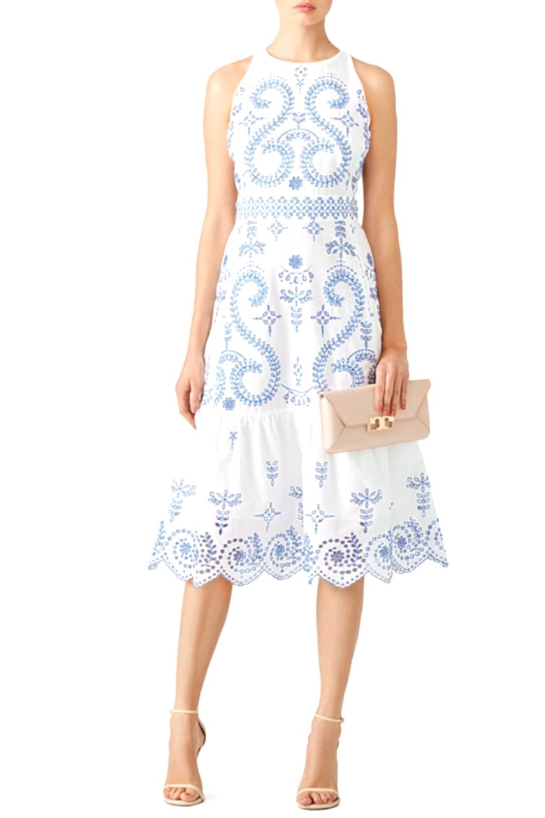 sleeveless fitted white dress with blue embroidery and ruffle bottom