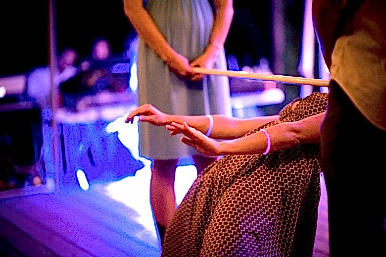 Woman playing limbo at wedding reception