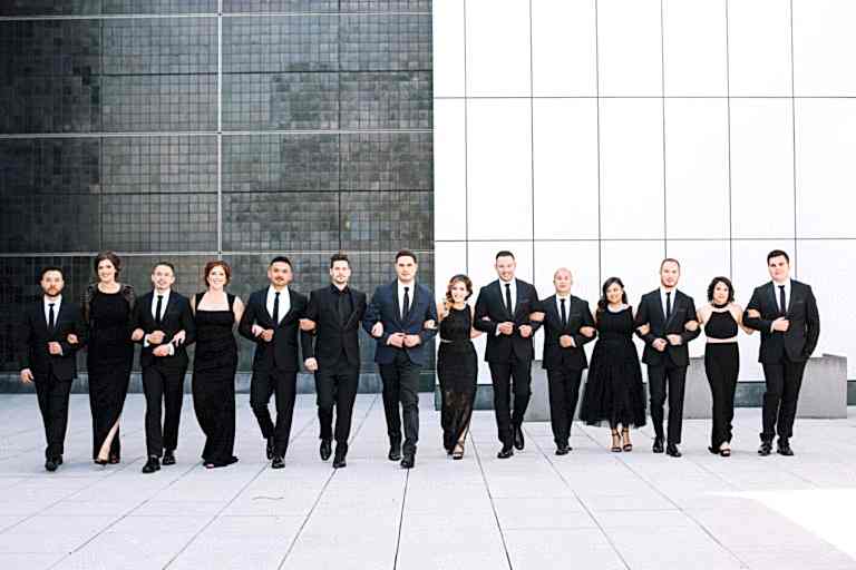 Long line of bridesmaids and groomsmen in black