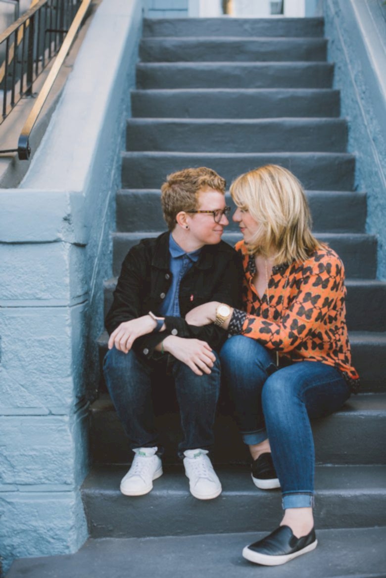 two queer women sitting on steps