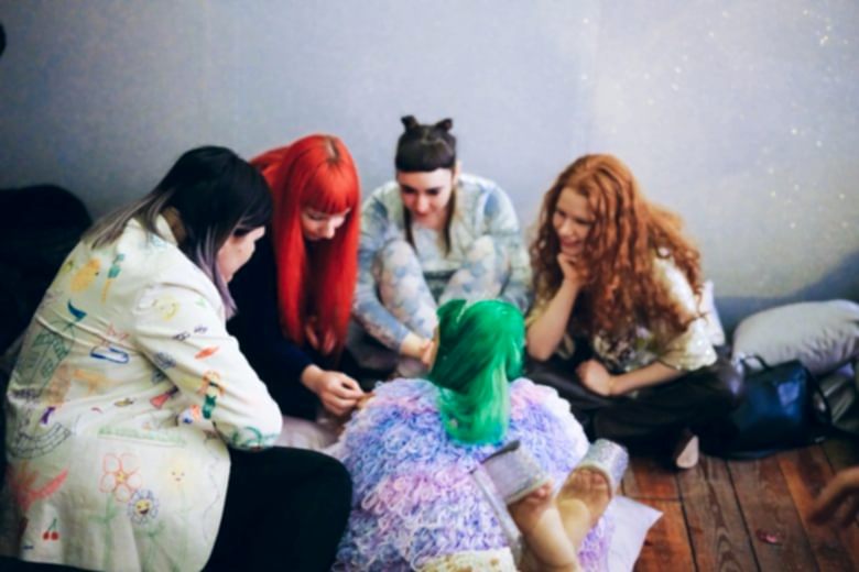 Women sitting on the ground in a circle
