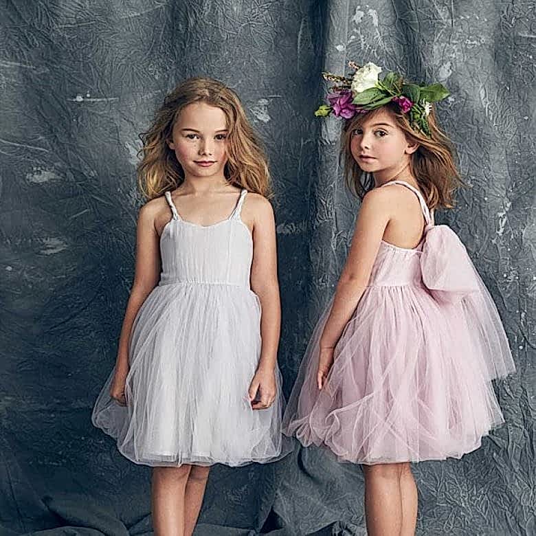 two little girls wearing modern tulle flower girl dresses