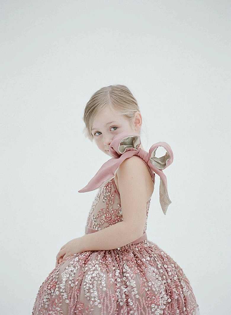 pink sequin dress with a large shoulder bow