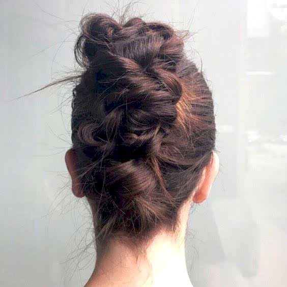 Messy twisted and braided french twist, with the front tightly pulled back, from behind
