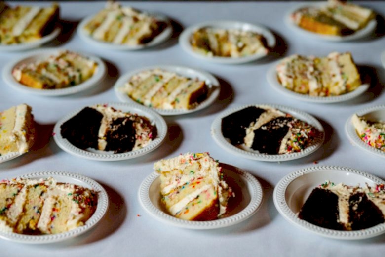 Slices of wedding cake on small plastic plates