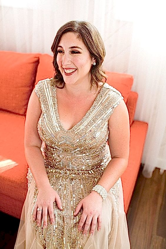 woman in ’20s vintage-style gold beaded dress with shoulder length hair, side parted, in loose waves