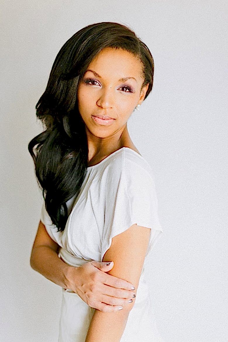 woman with long dark hair with deep side part and sleek waves cascading down shoulder