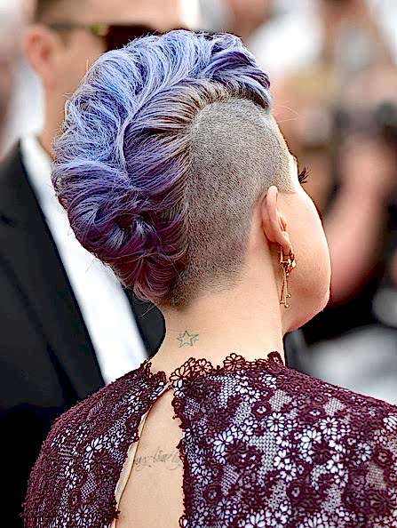 Kelly Osborn from behind with lavender locks, shaved into a wide mohawk and curled into a faux-hawk