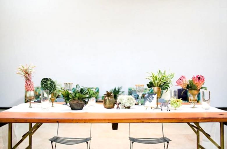Wedding decorations featuring tablescape with succulents and candles.