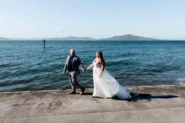 A couple walks along the waterfront 