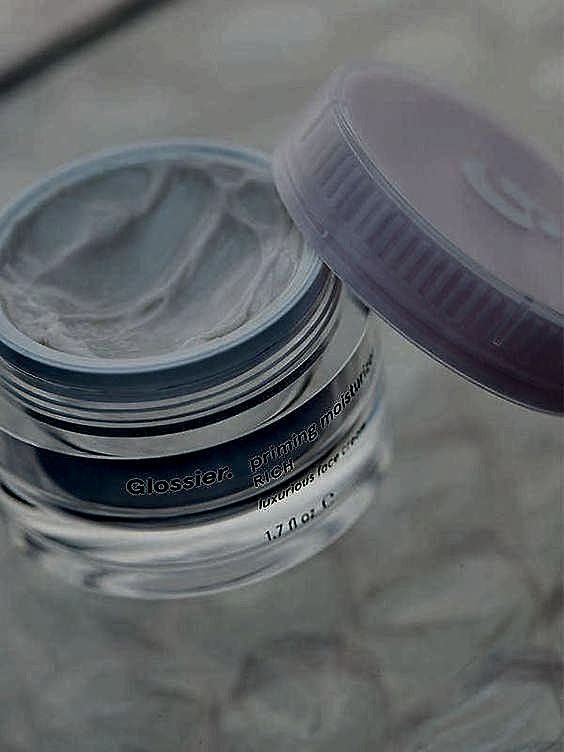 Jar with pink lid with Glossier skincare priming moisturizer rich cream