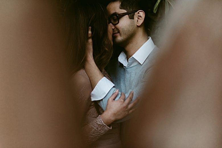 couple kisses in a secret space