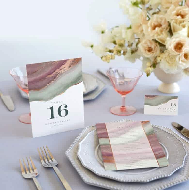 Wedding decorations featuring table setting with china, agate print table number, menu, and place card.