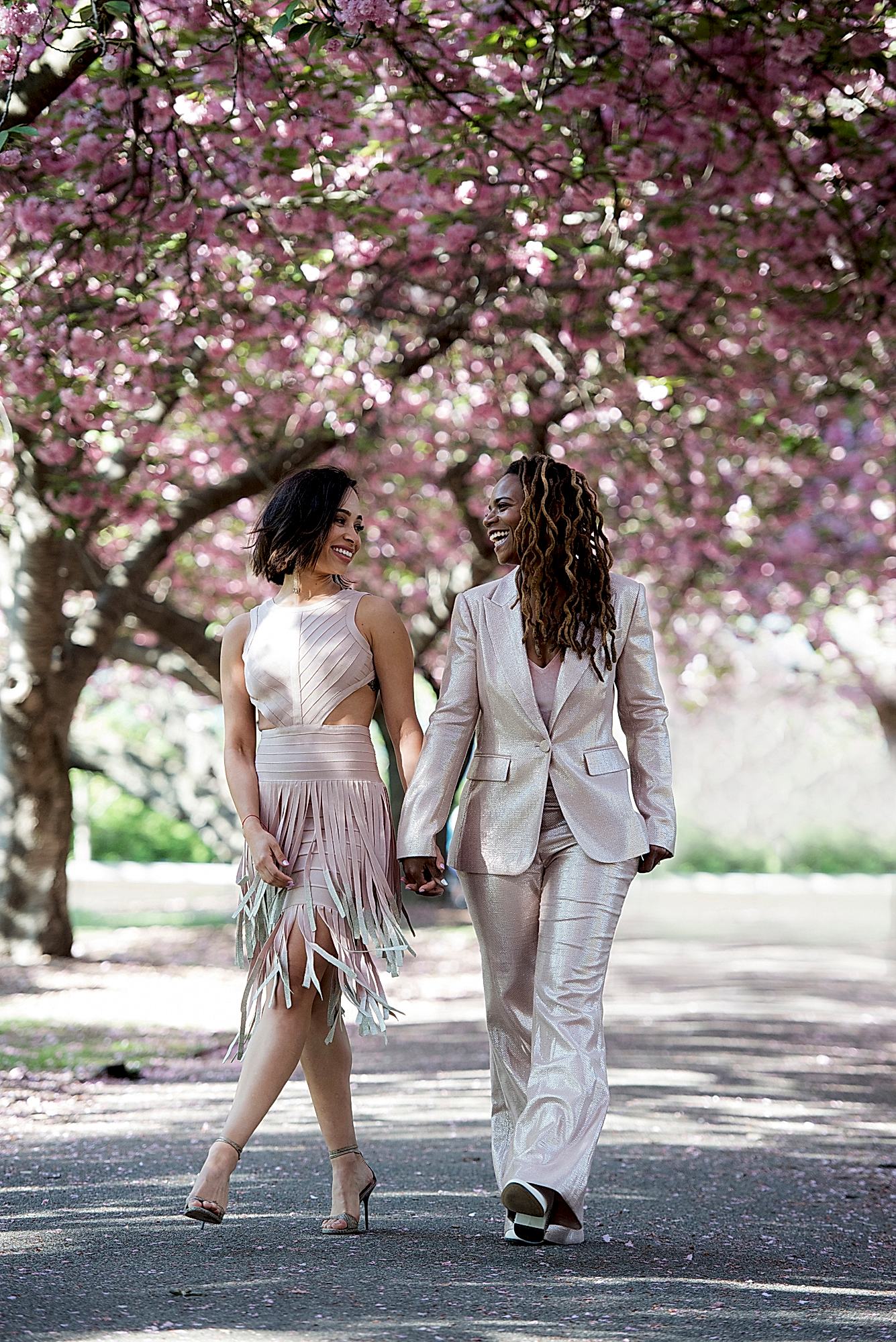 Two women walk down a path in the park