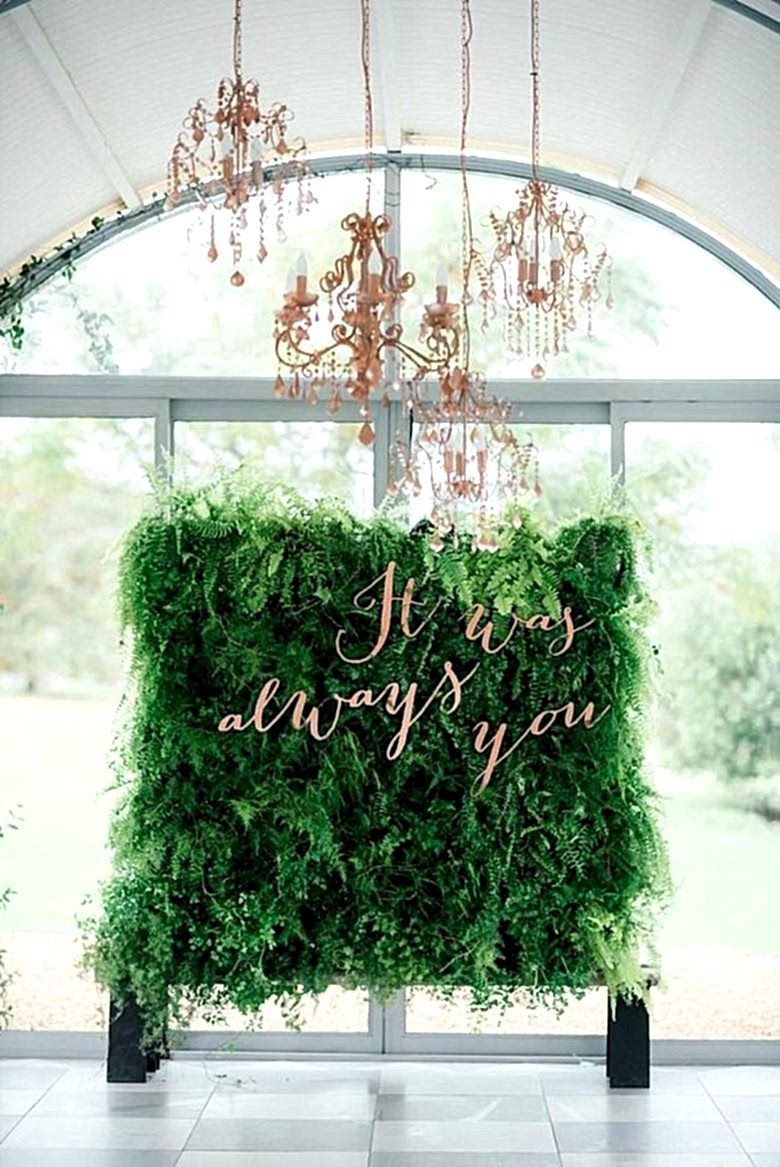 living wall backdrop with words "it was always you" in front of large windows