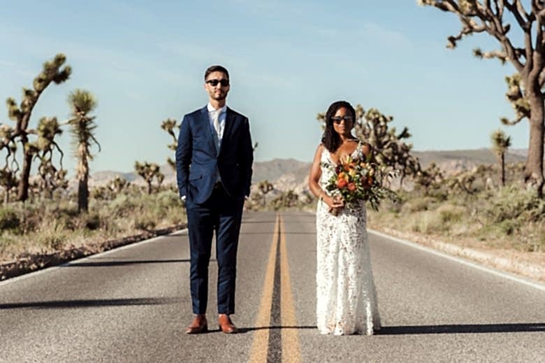 bride and groom standing on Joshua Tree highway
