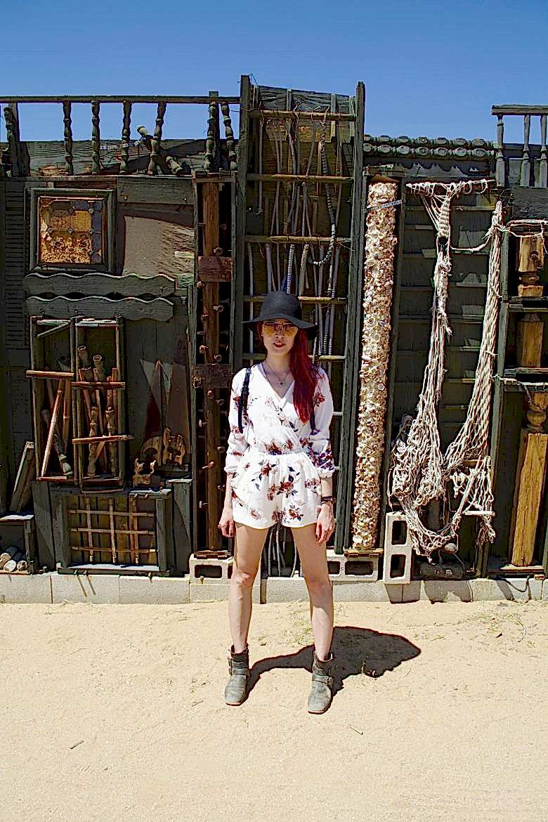 woman against antique furniture display in Joshua Tree