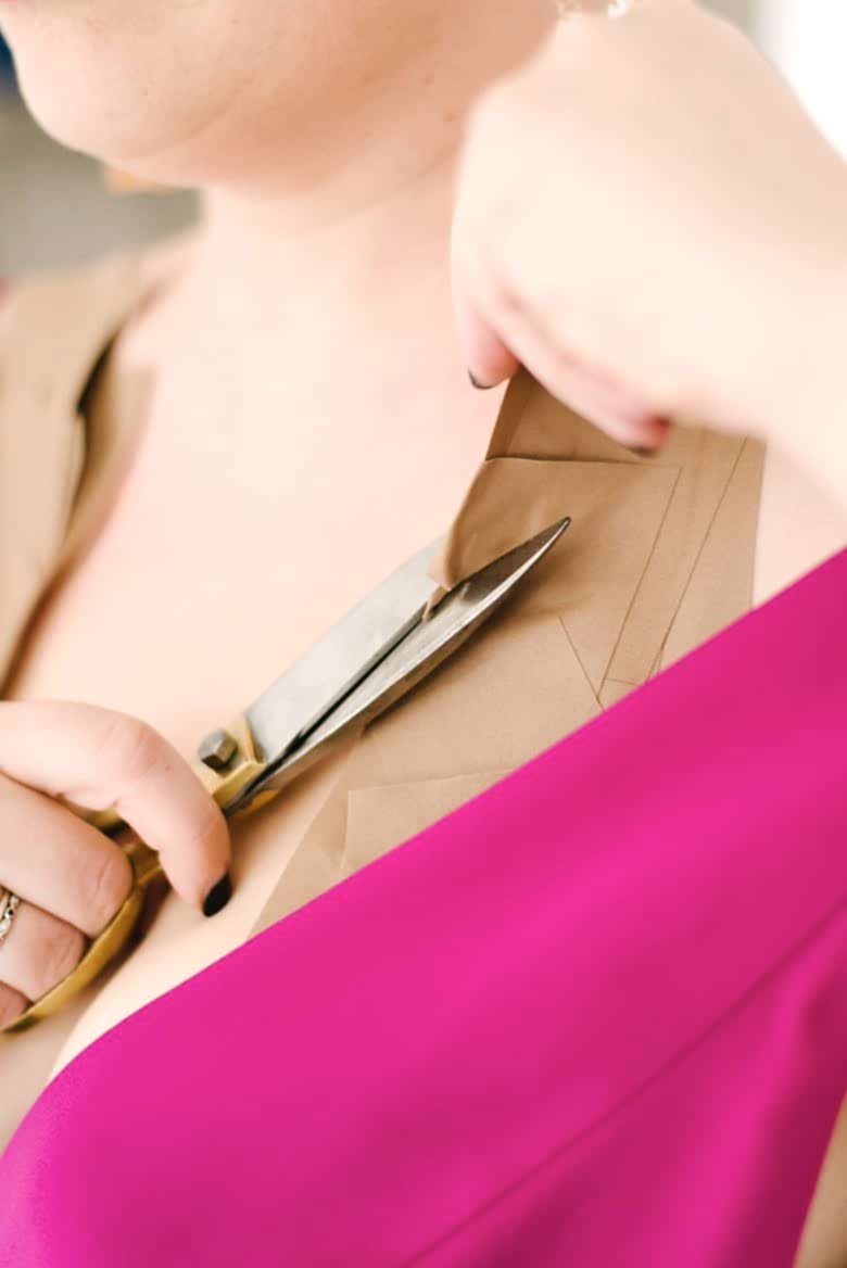 closeup of scissors cutting gaffer tape bra down to size