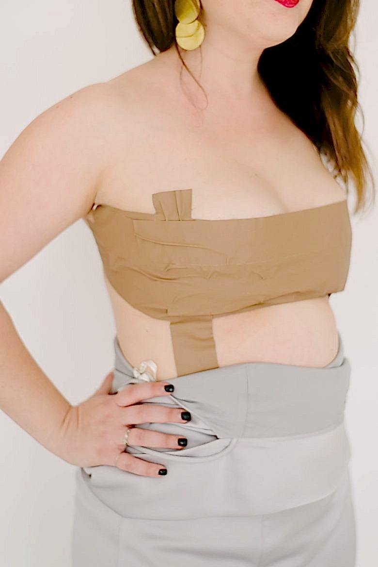 sideview of strapless gaffer tape bra on brunette