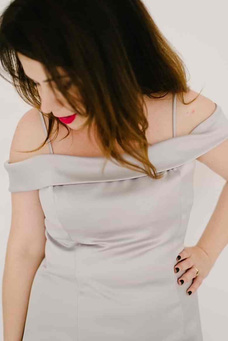 closeup of woman in silver drop shoulder dress