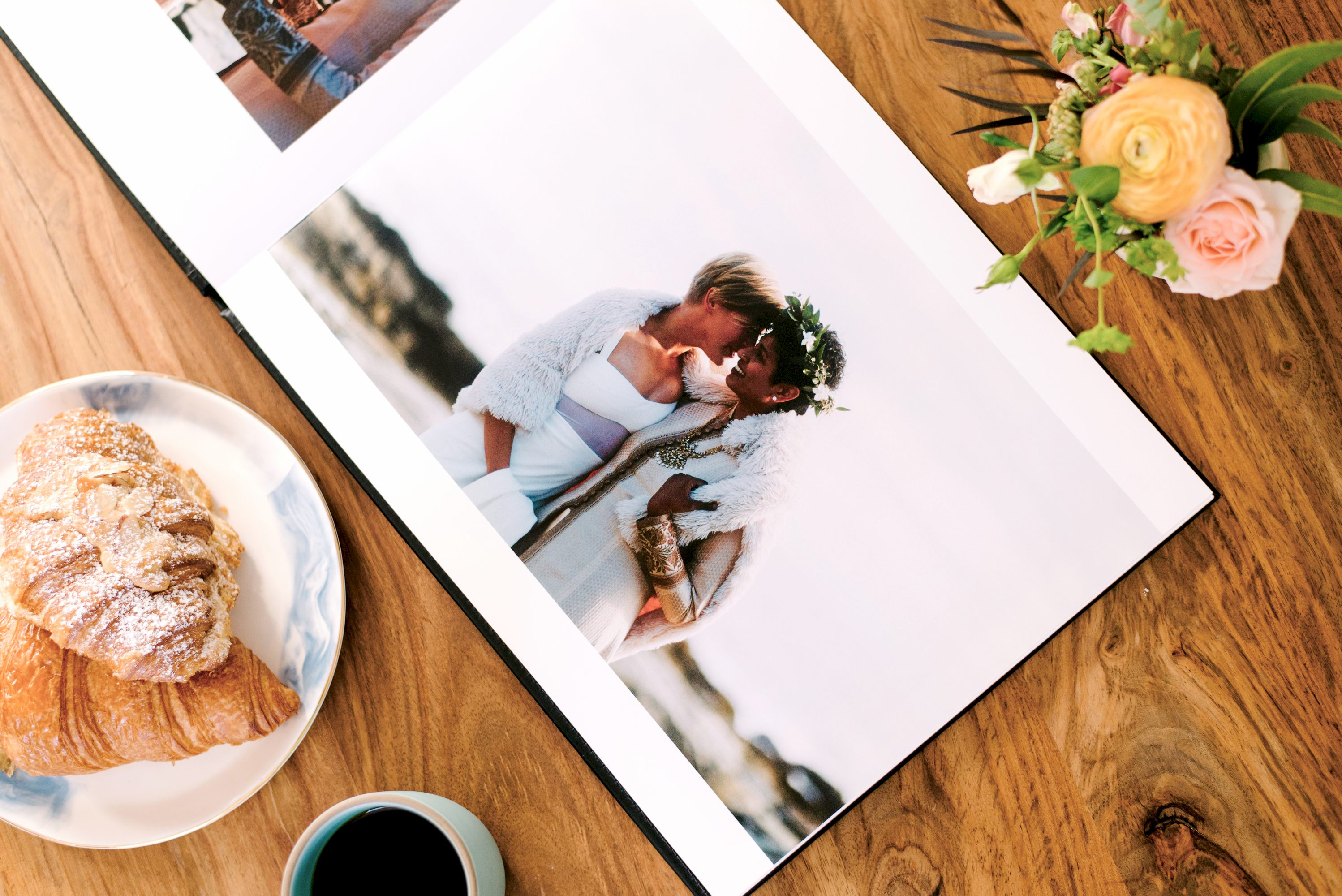 Overhead photo of an open album on a table with breakfast items.